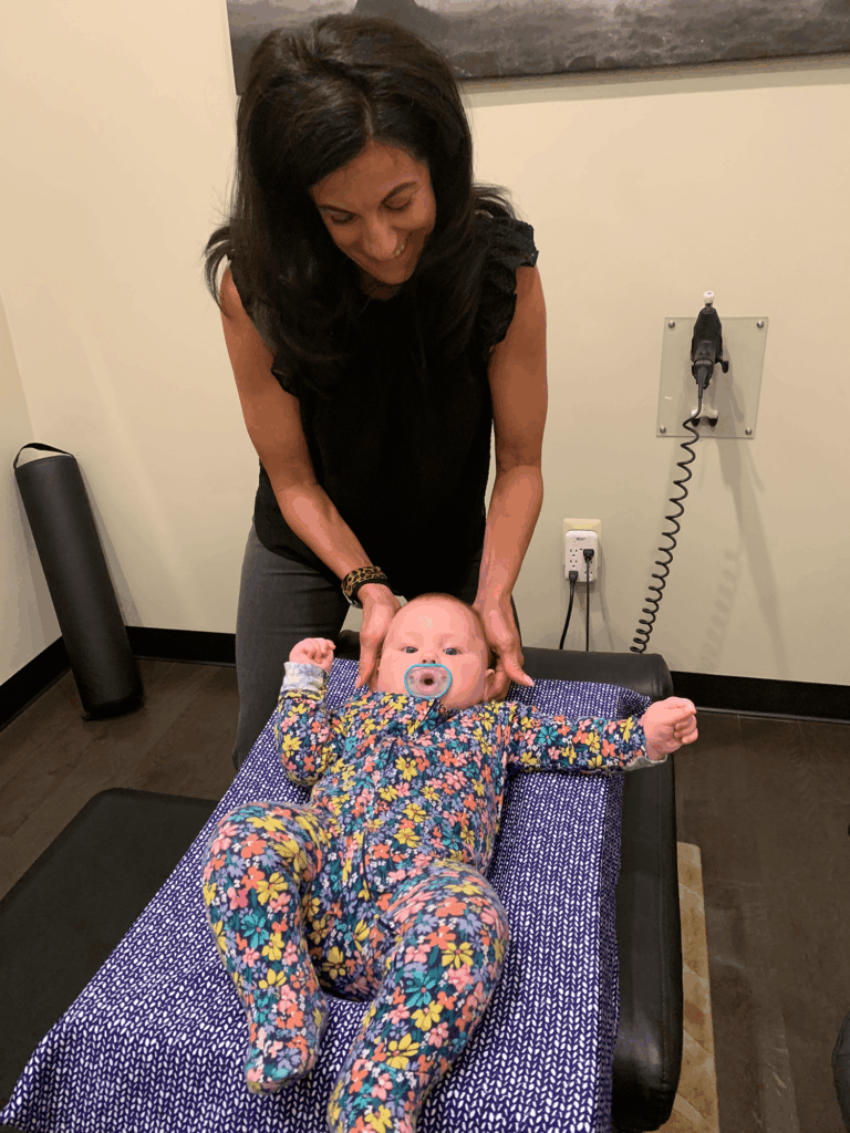 Dr. Christine Stewart giving baby, pediatric care treatment